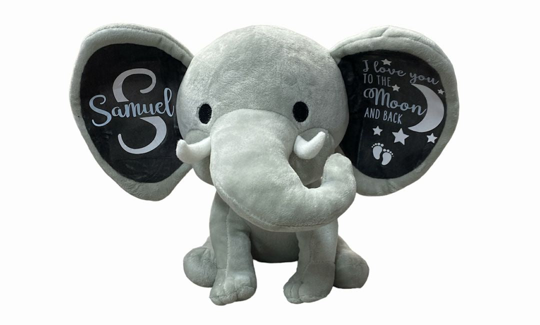 Gray Elephant Plush with Personalized ears with baby name and message sitting on white background. Little Gift Nook.