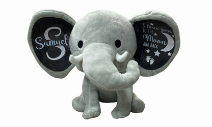 Gray Elephant Plush with Personalized ears with baby name and message sitting on white background. Little Gift Nook.