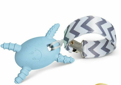 The blue Molar Magician molar back teether teething egg with 4 textured "arms" and a gray striped strap laying on a white background.