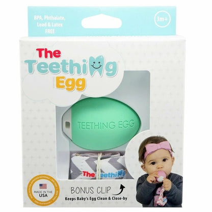 The Teething Egg mint green egg shaped teether in package box on a white background. Little Gift Nook