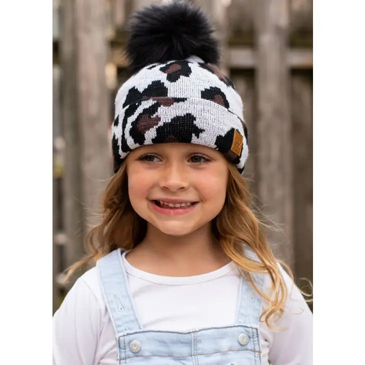 White Black Cow Print Child Pom Hat. Black furry pom pom hat top.- Little Gift Nook