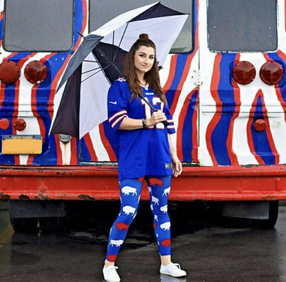 woman wearing royal blue, red, and white buffalo print silky soft leggings holding umbrella. 