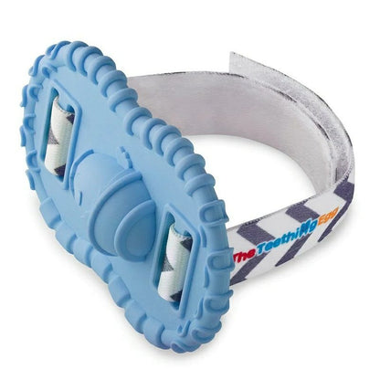 Baby wrist Wristie Teether in Bue with velcro strap sitting on white background. 