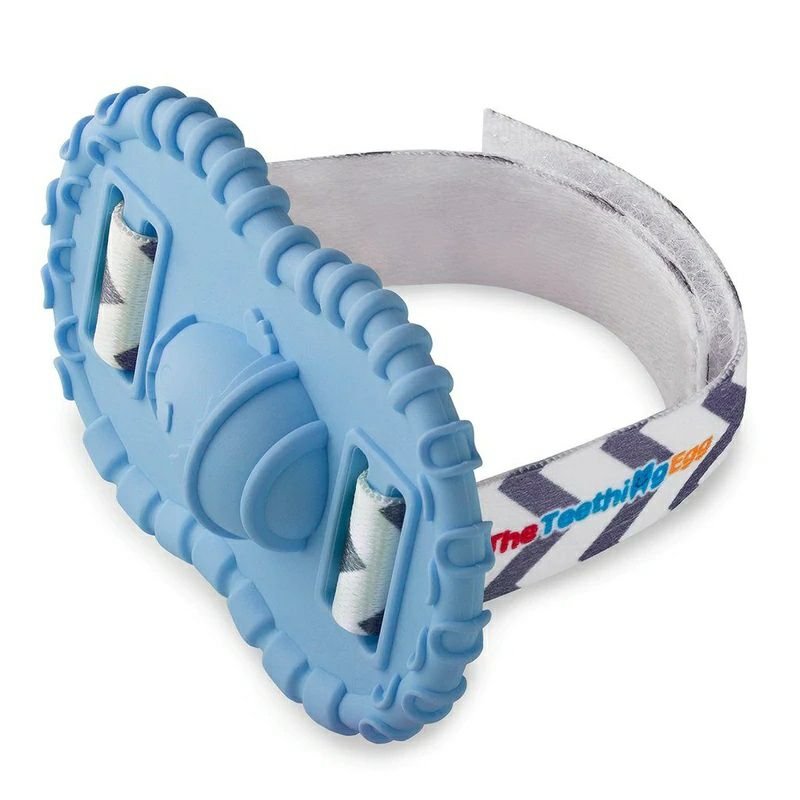 Baby wrist Wristie Teether in Bue with velcro strap sitting on white background. 