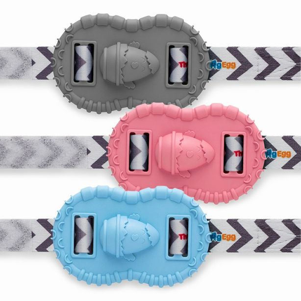 The Wristie Teether in blue, pink, and gray by the Teething Egg company sitting on a white background.